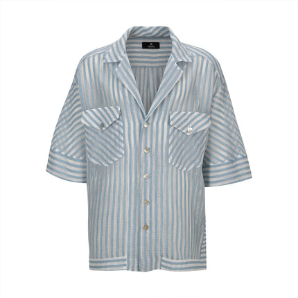 The Nopin Striped Oversized Shirt is a modern piece with asymmetrical baby blue and white stripes with side slits. The shirt has dropped shoulders, pockets with flaps and buttons on the front. Buttoned in front with NOPIN mother-of-pearl buttons.