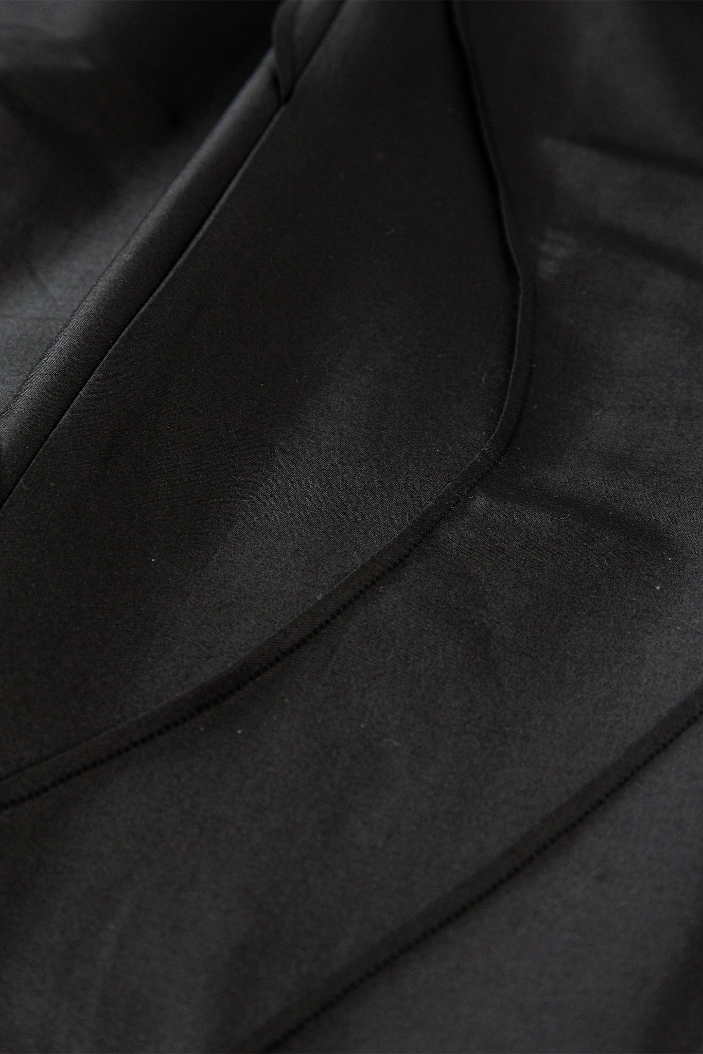 Close-up of a black leather jacket with visible stitching