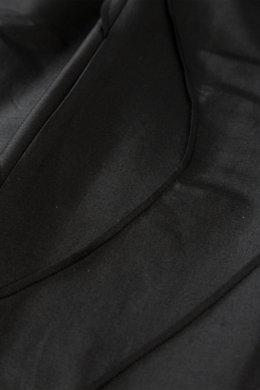 Close-up of a black leather jacket with visible stitching
