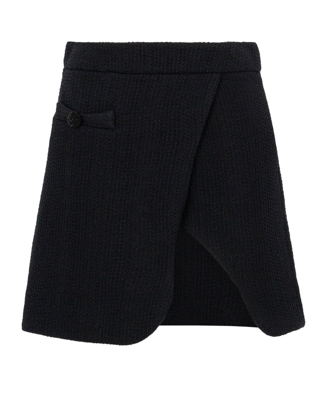 Black skirt with a button detail on a white background