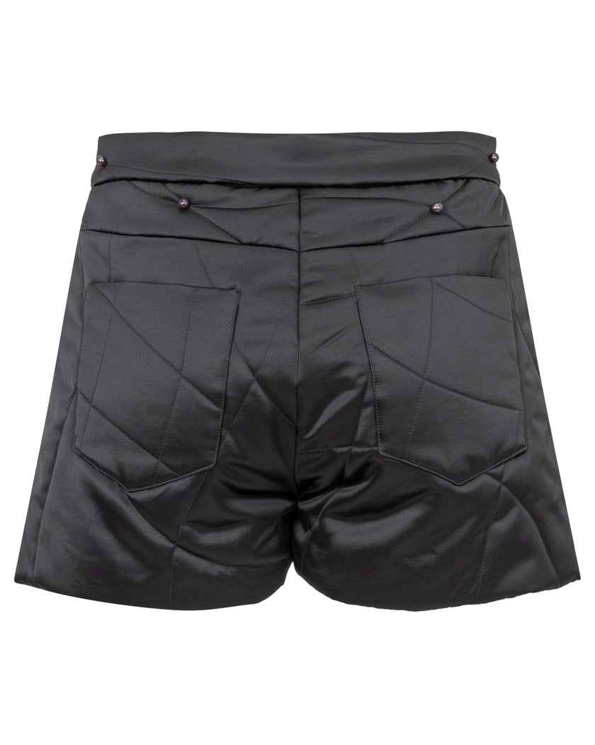 Black quilted shorts on a white background