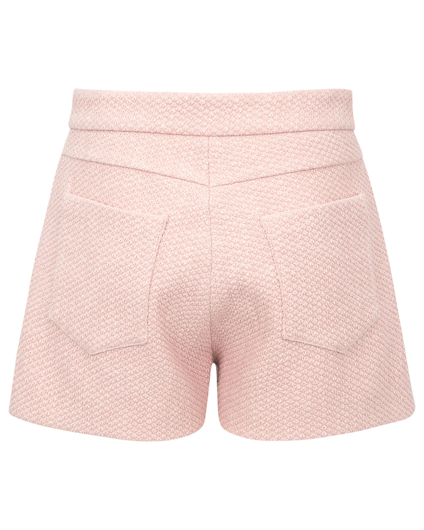 Pink textured shorts on a white background