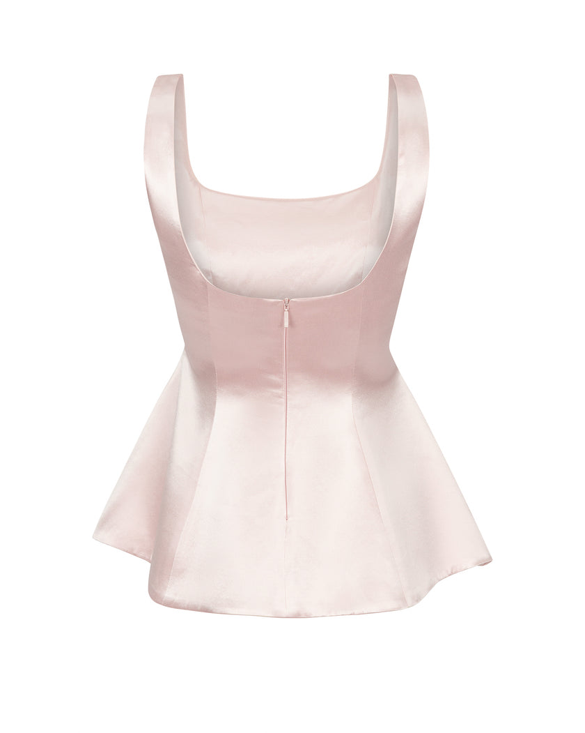 Light pink peplum top on a white background