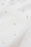 Close-up of pearl earrings on a white background