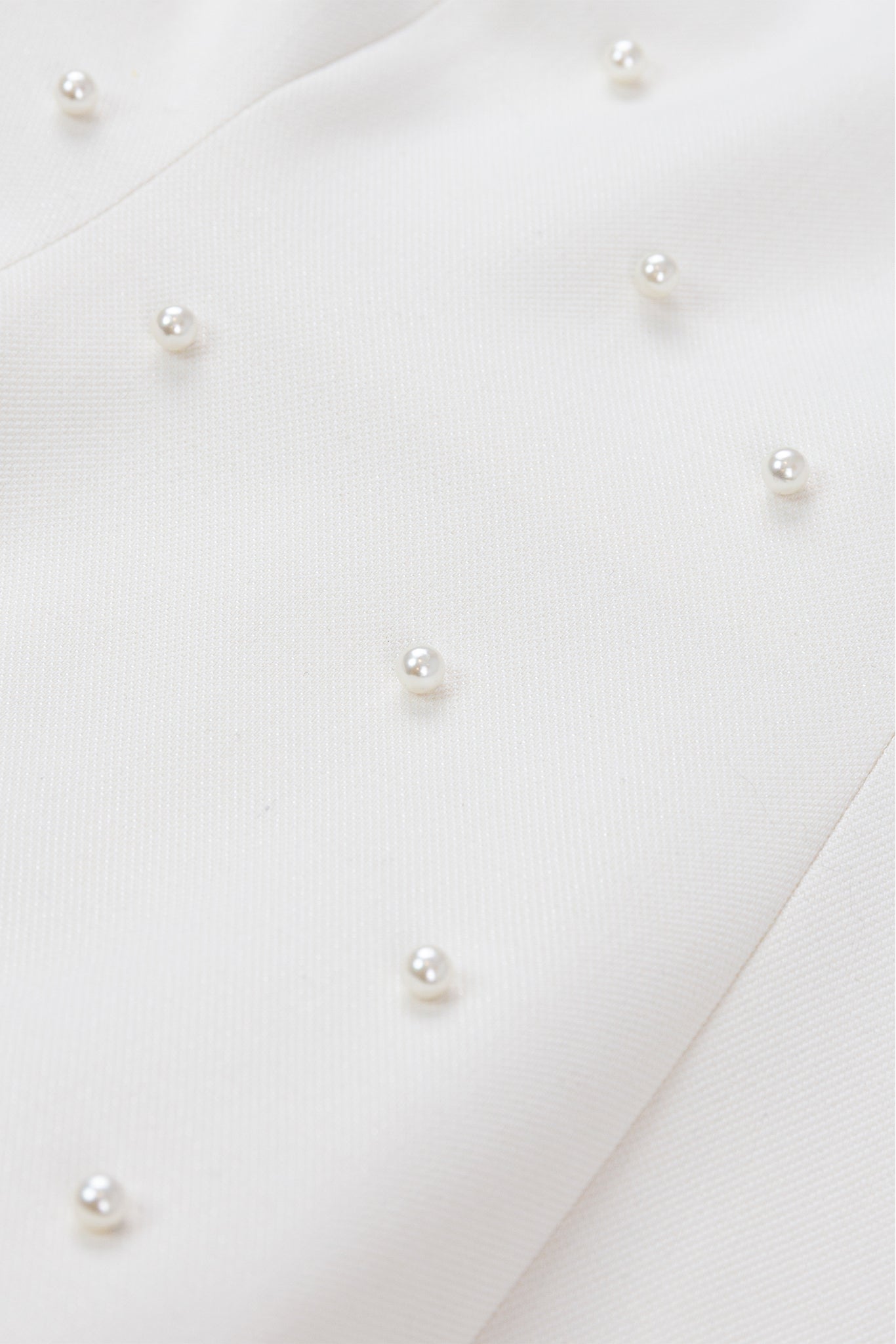 Close-up of pearl earrings on a white background