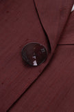 Close-up of a button on a burgundy fabric