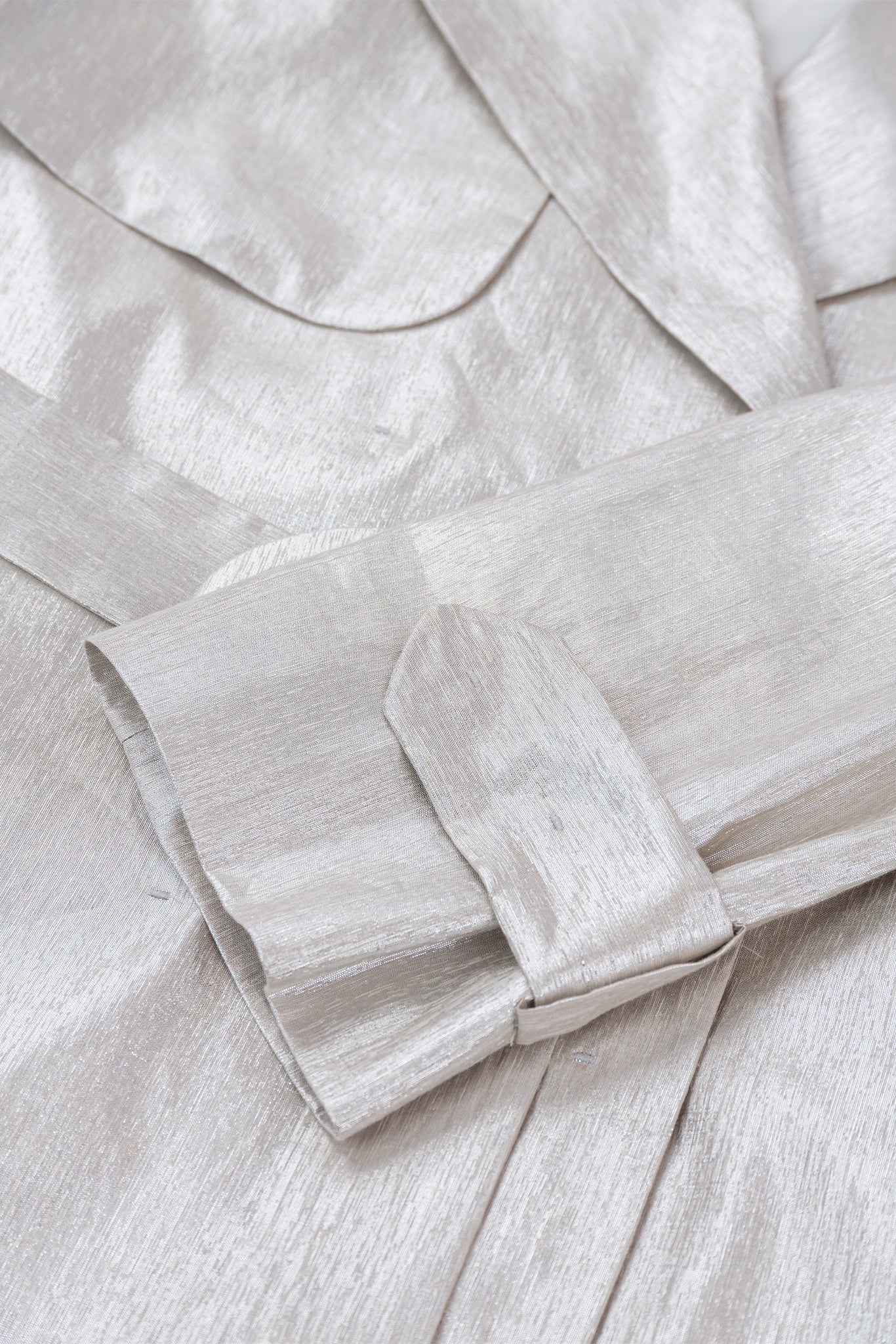 Close-up of a light gray fabric with a bow detail
