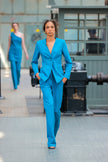 Woman in a blue suit walking in an industrial setting