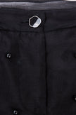 Close-up of a black coat with buttons on a dark background