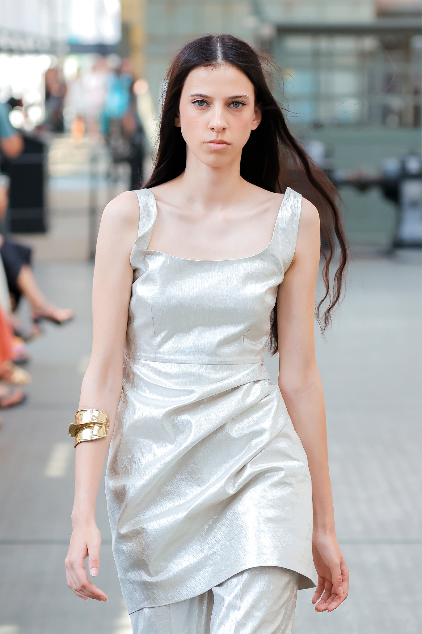 Woman wearing a light-colored dress with a blurred background