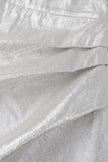 Close-up of textured white fabric with folds