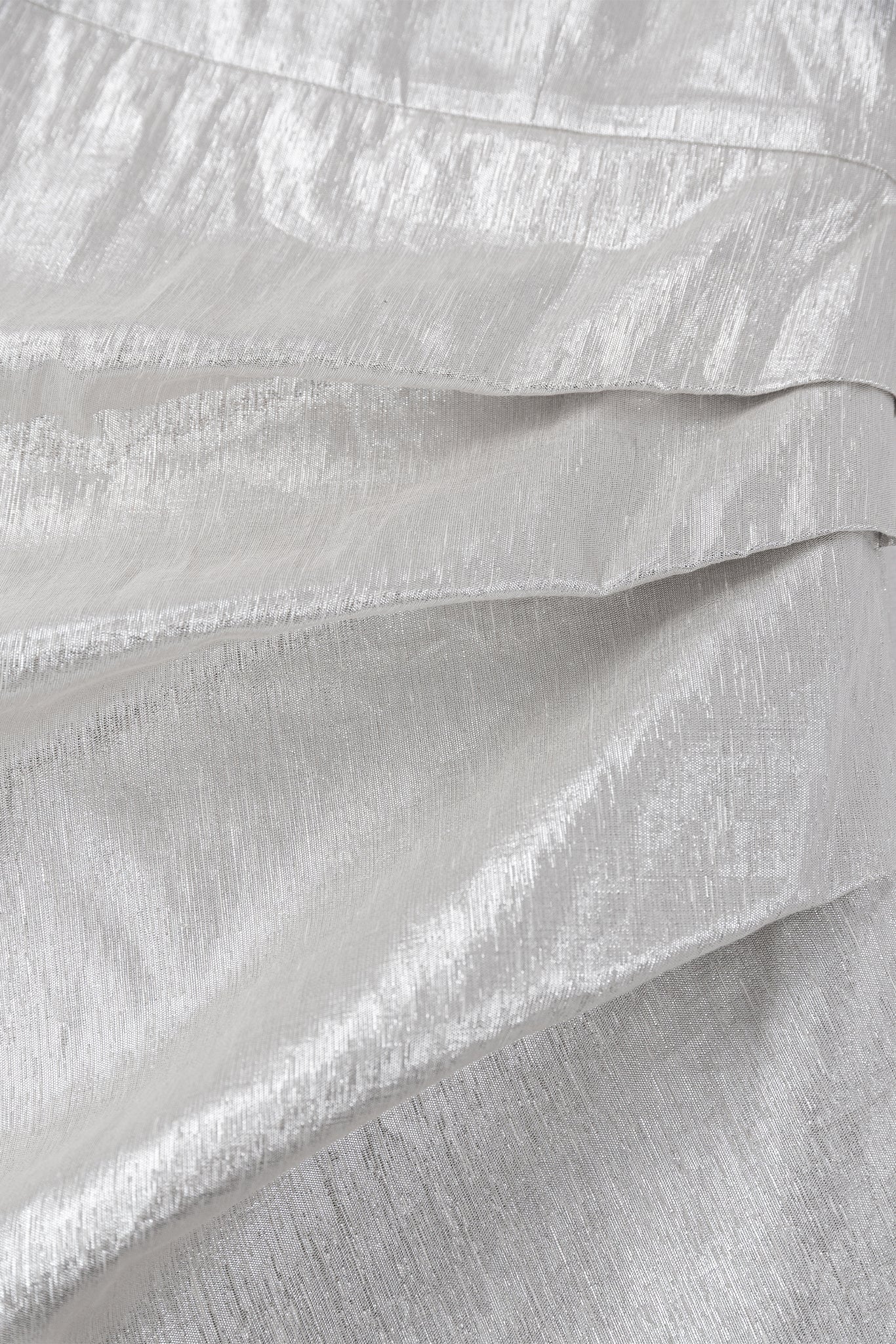 Close-up of textured white fabric with folds