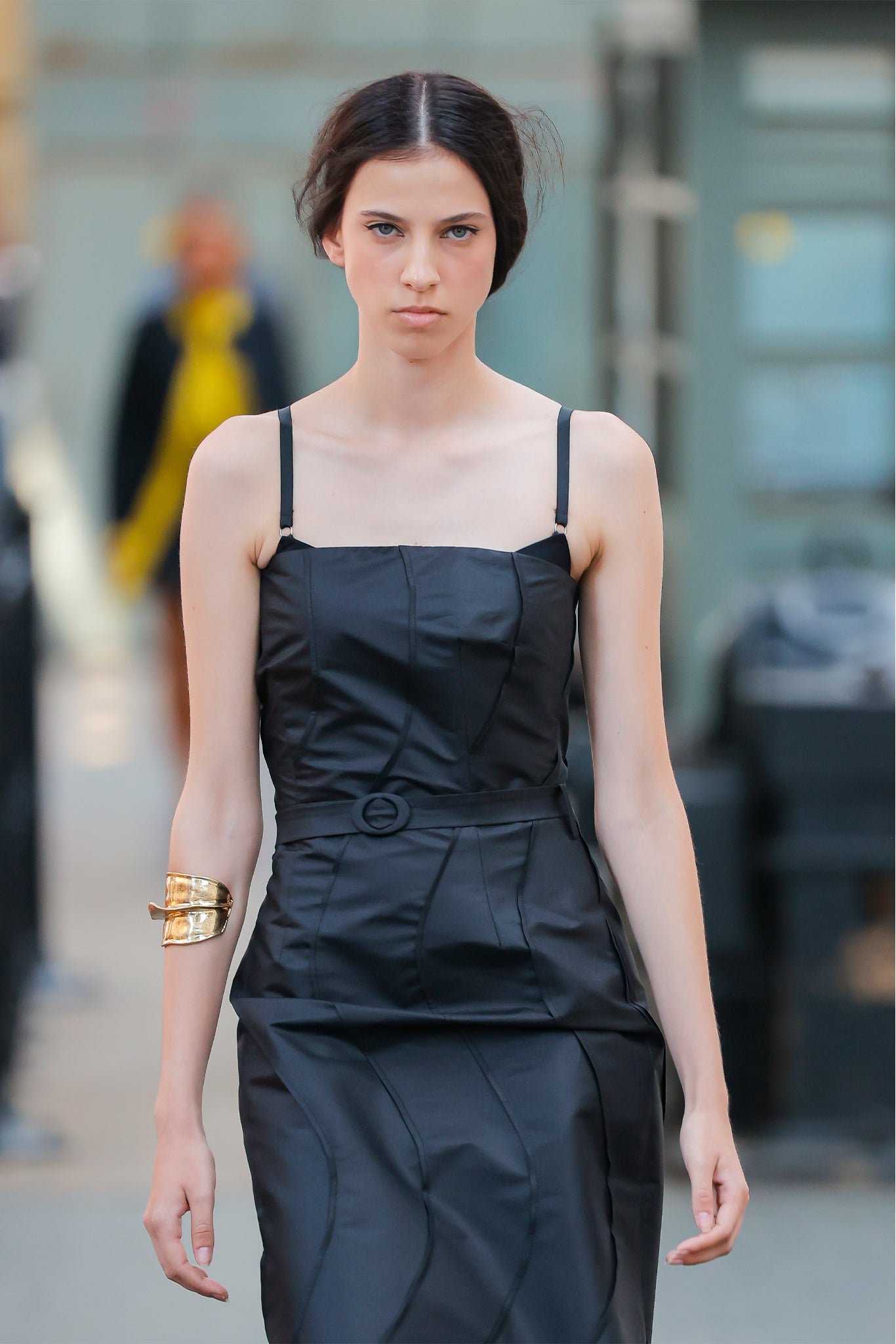 Woman wearing a black dress with a blurred background