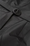 Close-up of a black coat with a belt and button detail.