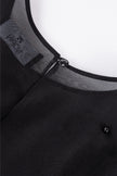Close-up of a black garment with a zipper and visible brand logo on a white background