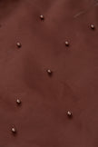 Brown leather surface with small metallic studs