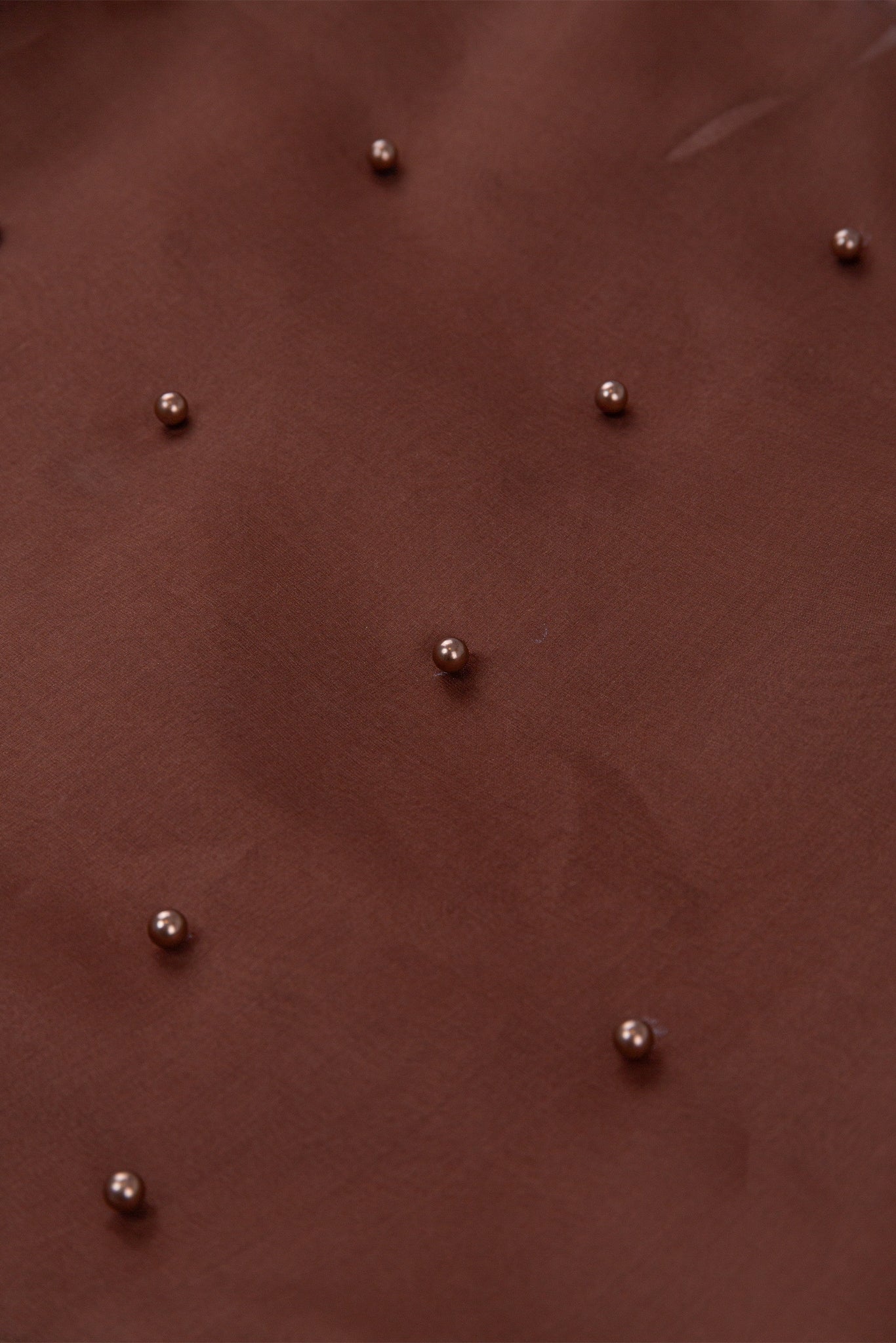 Brown leather surface with small metallic studs