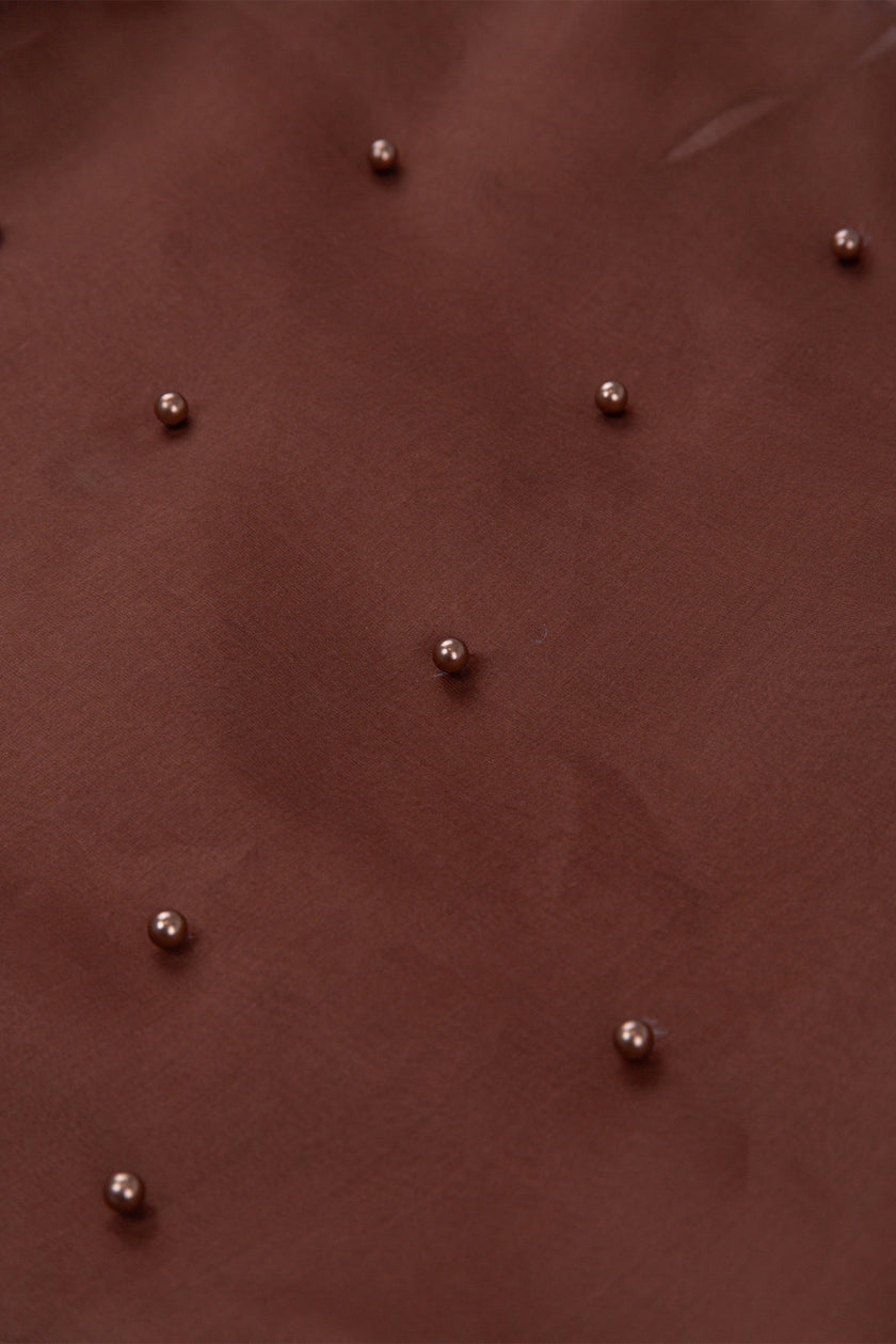 Brown leather surface with small metallic studs