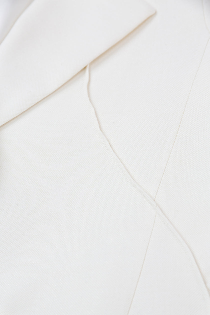 Close-up of a white garment with a subtle pattern
