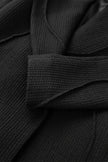 Close-up of a black textured fabric with a focus on texture and color.