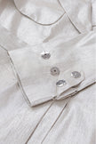 Close-up of a light gray shirt with buttons and collar details.