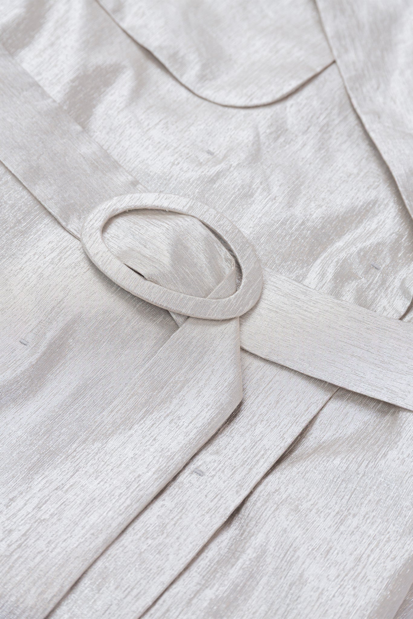 Close-up of a light gray fabric with a belt