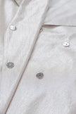 Close-up of a light gray textured fabric with buttons