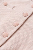 Close-up of a pink textured fabric with buttons