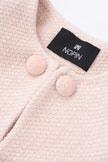 Close-up of a pink textured garment with aNOPIN label.